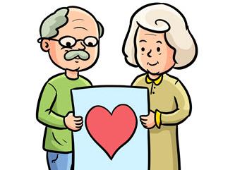 Babcia i dziadek trzymają kartkę z narysowanym sercem.